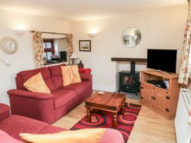 A living room with a sofa and coffee table at Bridge Cottage in Budleigh Salterton