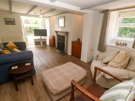 A living room with a sofa and coffee table at Greenways in Perranporth