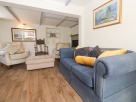 A living room with a sofa and armchair at Greenways in Perranporth