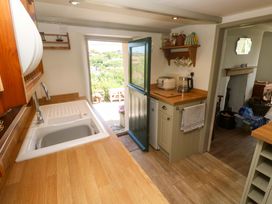 A kitchen with a sink and wooden countertop at Greenways in Perranporth