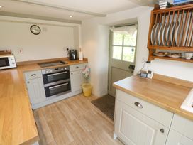 A kitchen with appliances and wooden countertops at Greenways in Perranporth
