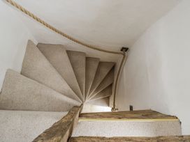 A staircase with carpet and wooden railing at 8 Gloucester Street 