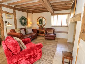 A living room with a sofa and armchair at 8 Gloucester Street Winchcombe