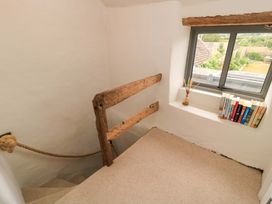 A staircase with a railing and window at 8 Gloucester Street Winchcombe