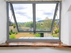 A window overlooking a garden and mountains at 8 Gloucester Street Winchcombe
