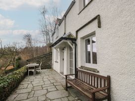 An outdoor area with a wooden bench and table at Brockstones in Grasmere