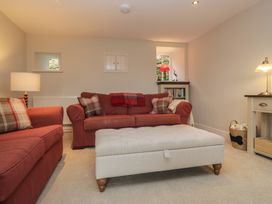 A living room with a sofa and lamp at Brockstones in Grasmere