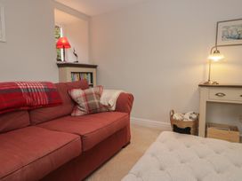 A living room with a sofa and a lamp at Brockstones in Grasmere