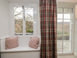 A snug with a window seat and cushions at Brockstones in Grasmere