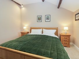 A bedroom with a bed and bedside tables at Brockstones in Grasmere