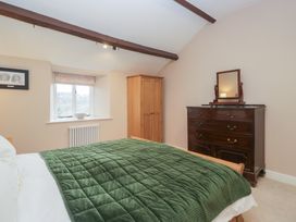 A bedroom with a bed and furniture at Brockstones in Grasmere