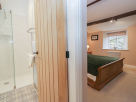 A bathroom with a shower and a view into a bedroom at Brockstones in Grasmere