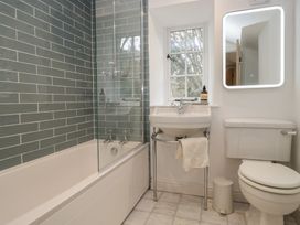 A bathroom with a bathtub, sink, and toilet at Brockstones in Grasmere