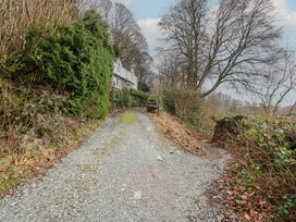 A gravel path leading to a house surrounded by trees and bushes at Brockstones in Grasmere