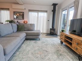 A living room with a sofa and television at Bay View in Portreath