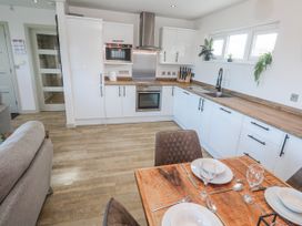A kitchen with a dining area at Bay View in Portreath