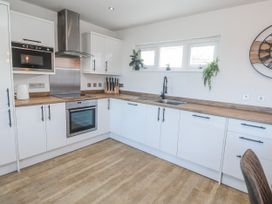 A kitchen with cabinets and appliances at Bay View in Portreath