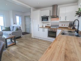 A kitchen with cabinets and appliances at Bay View in Portreath