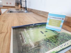 A kitchen countertop with a sink and an information pack at Bay View