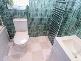 A bathroom with a toilet and sink at Bay View in Portreath