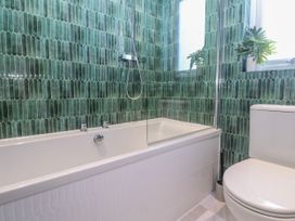 A bathroom with bathtub and toilet at Bay View in Portreath