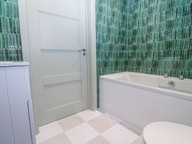 A bathroom featuring a bathtub and toilet at Bay View in Portreath