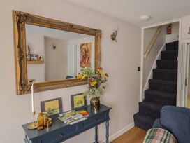 A hallway with a mirror and table at 6 Bedford Place in Bridport