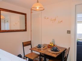 A dining room with a table set for two at 6 Bedford Place in Bridport