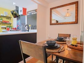 A dining room with a table set for meals at 6 Bedford Place in Bridport