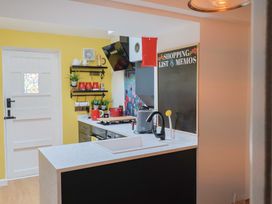 A kitchen with a kettle and red cups at 6 Bedford Place in Bridport