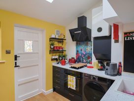 A kitchen with modern appliances and colorful decor at 6 Bedford Place in Bridport