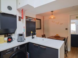A kitchen with appliances and dining area at 6 Bedford Place Bridport