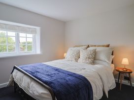 A bedroom with a bed and lamps at 6 Bedford Place in Bridport