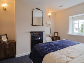 A bedroom with bed and a mirror at 6 Bedford Place in Bridport