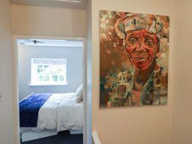 A bedroom with a view of a bed and a painting at 6 Bedford Place in Bridport
