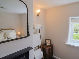 A bedroom with a bed and towels on a rack at 6 Bedford Place in Bridport
