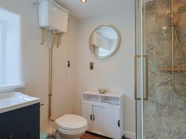 A bathroom with a sink, toilet, and shower at 6 Bedford Place in Bridport