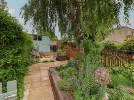 A garden with a pathway and shed at 6 Bedford Place in Bridport