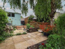A garden with a shed, flowers, and a pathway at 6 Bedford Place in Bridport
