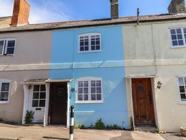 A row of houses with different colored facades at 6 Bedford Place Bridport