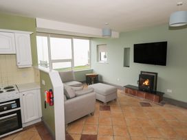 A living room with a sofa and fireplace at No.3 Beach Cottages, Keel, County Mayo
