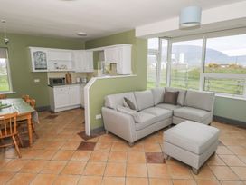 A living room with a sofa and dining area at No.3 Beach Cottages in Keel, County Mayo