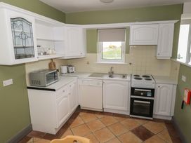 A kitchen with appliances and cabinetry at No.3 Beach Cottages in Keel, County Mayo