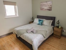 A bedroom with a bed and nightstand at No.3 Beach Cottages, Keel, County Mayo