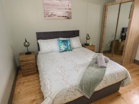 A bedroom with a bed and nightstands at No.3 Beach Cottages in Keel, County Mayo