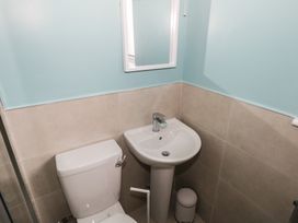 A bathroom with a toilet and sink at No.3 Beach Cottages in Keel, County Mayo