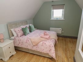 A bedroom with a bed and nightstand at No.3 Beach Cottages in Keel, County Mayo