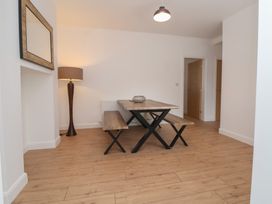 A dining room with a table and a lamp at 5 Marsh Lane in Flint