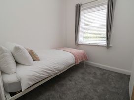 A bedroom with a single bed and window at 5 Marsh Lane, Flint