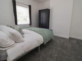 A bedroom with a bed and wardrobe at 5 Marsh Lane in Flint
